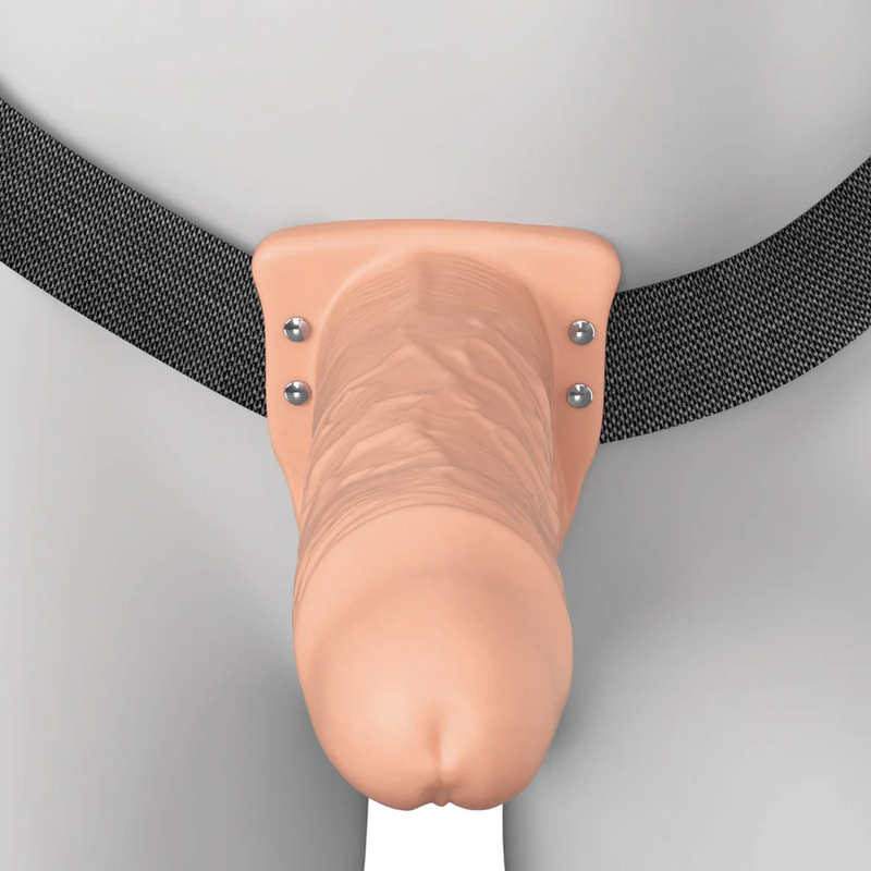 Vanilla 6-inch Elite Silicone hollow dildo with realistic texture, attached to a black strap-on harness.