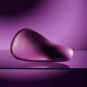Smooth, compact, deep purple silicone vibrator with a cupped shape, designed for oral play.
