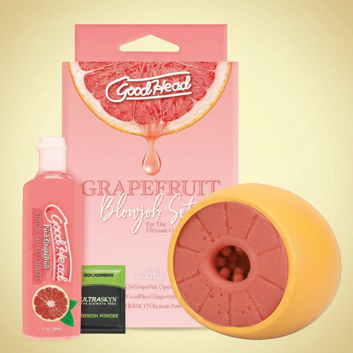 The Goodhead Grapefruit Blowjob Set includes Slick Head Glide, a grapefruit-themed ULTRASKYN stroker, condoms, and powder sachet, all displayed on a vivid yellow-pink gradient backdrop.