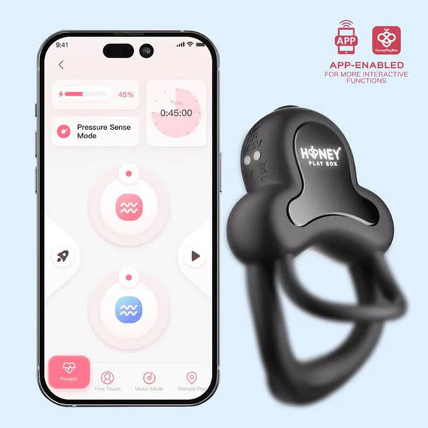 A smartphone shows an app interface with controls and a timer beside the Anello App-Controlled Vibrating Double Cock Ring with Clitoral Stimulator, designed for interactive experience.