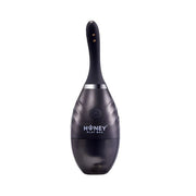 The Bulby Auto Spray Anal Douche System by Honey Play Box is a black, oval-shaped device with a curved handle and USB rechargeability, offering convenient, portable cleaning. The "Honey Play Box" logo appears on its base against a white background.