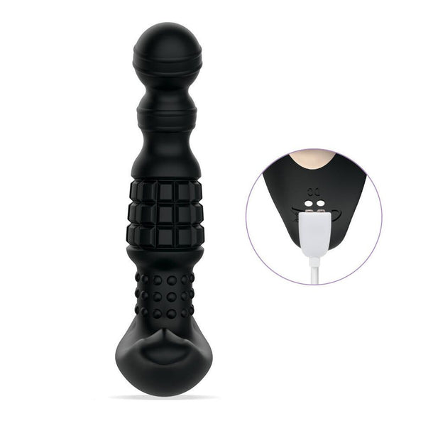 The Pineapple Man Rolling Bead Prostate Vibrator with App Control is a black silicone massager featuring textured surfaces, rolling beads, and a rounded tip. An inset highlights the charging port with a white USB cable plugged in.