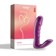 The purple Rora 2 App-Controlled Rotating G-Spot Vibrator & Clit Stimulator by Honey Play Box stands upright beside its pink and orange gradient box, which features an abstract outline of a woman on the packaging.