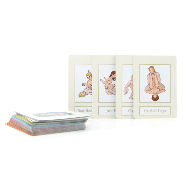 The A year of SEX! Card Game is shown on a white surface, featuring cards with cartoon couples in various sex positions labeled with names like "Saddled" and "Curled Legs"—ideal for playful couples' games.