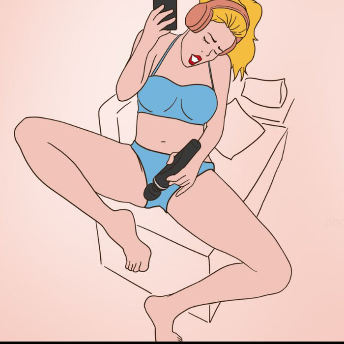 A cartoon woman with blonde hair, wearing blue underwear and large headphones, is lounging on a couch. She is holding a smartphone and a Lovense Domi 2 Powerful App Controlled Wand Vibrator by Lovense. Her facial expression appears to be one of pleasure. The background is a solid light pink color.