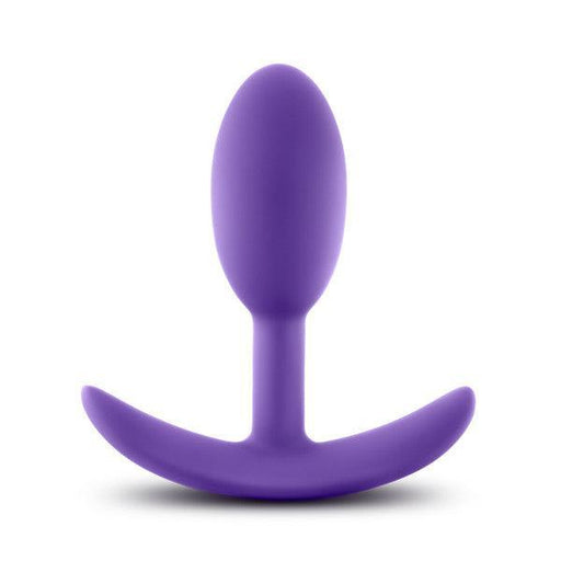 The Luxe Small Wearable Silicone Vibra Slim Plug - Purple by Blush is expertly crafted from hypoallergenic silicone. It boasts a smooth, bulbous tip and a curved base designed for comfort and safety. This sleek, seamless anal toy offers both style and peace of mind.