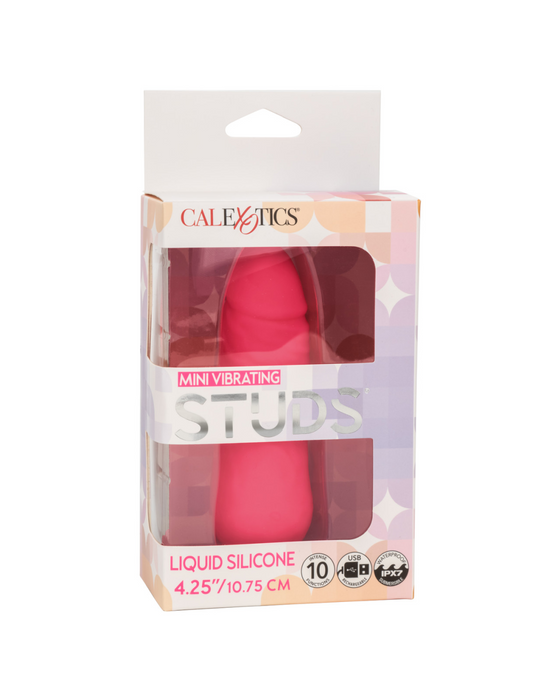 A pink textured Vibrating Stud Mini Cock Shaped Bullet Vibrator - Pink is displayed inside its packaging. The box features the brand name "CalExotics" at the top and highlights the toy's size (4.25 inches or 10.75 cm). The packaging also mentions 10 powerful vibration functions and premium liquid silicone material.