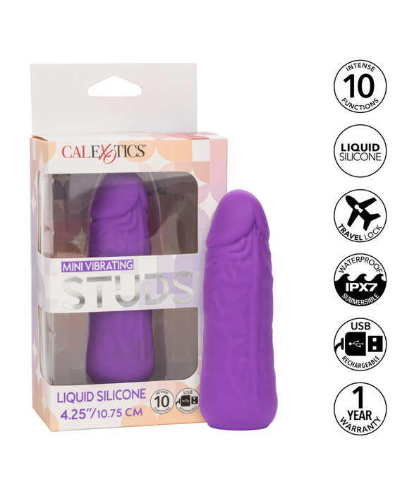 The image shows a purple CalExotics Vibrating Stud Mini Cock Shaped Bullet Vibrator - Purple inside its packaging. The package highlights features including powerful speeds of vibration, premium silicone, travel lock, waterproof (IPX7), USB rechargeable, a length of 4.25 inches, and a 1-year warranty.