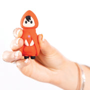 A hand holds the Little Red Discreet Powerful Bullet Vibrator, shaped like a small figurine with a red hooded outfit, black hair, and a heart on the chest, against a white background.