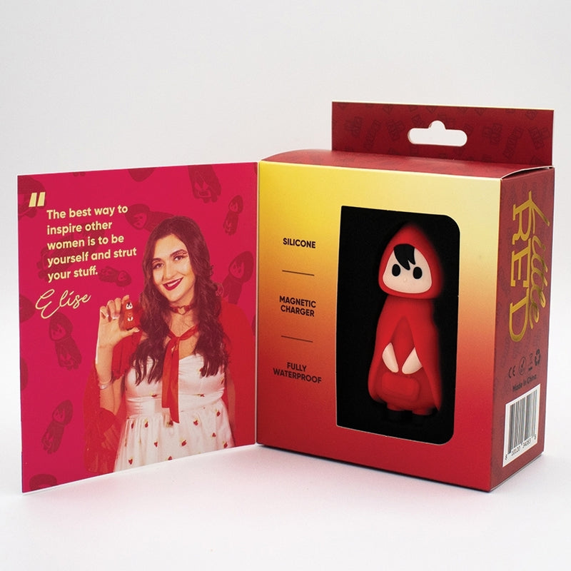 A retail box shows the Little Red Discreet Powerful Bullet Vibrator, shaped like a hooded cartoon character. Beside it, an open card has a woman in white holding the vibrator and a quote about empowering women to be themselves.