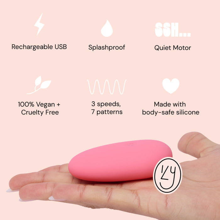 A hand holds the Ily Squishy Silicone Pebble Vibrator—pink, body-safe silicone, for clitoral stimulation. It’s USB rechargeable, splashproof, quiet, 100% vegan and cruelty free, with 3 speeds and 7 patterns.