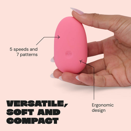 A hand holds the Ily Squishy Silicone Pebble Vibrator, a pink, oval-shaped device with 5 speeds, 7 patterns, and an ergonomic design. Bold text reads: "Versatile, soft and compact." Made from body-safe silicone for gentle clitoral stimulation.