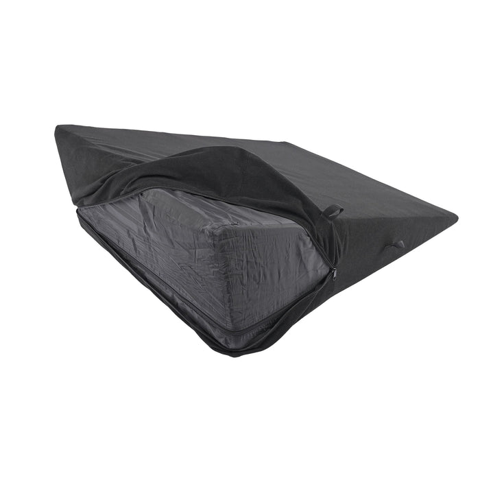 A Sportsheets Pivot Positioner Plus Large Sex Wedge Cushion, rectangular and black, is shown partially covered with a dark waterproof cover that features a zipper. The cover's top flap is folded back, exposing the high-density wedge cushion/mattress inside.