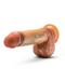 A realistic silicone dildo designed to resemble a human penis is shown against a plain white background. The Raphael Ultra Realistic 9.5 Inch Silicone Dildo with Sliding Foreskin - Caramel by Blush has a tan color, textured details, a flared suction cup base, and is positioned at an angle.