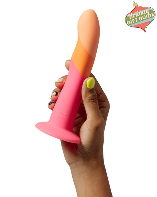 Hand holding a Lovehoney Romp Dizi Ultra Smooth 7 Inch Dildo With Suction Cup against a white background.