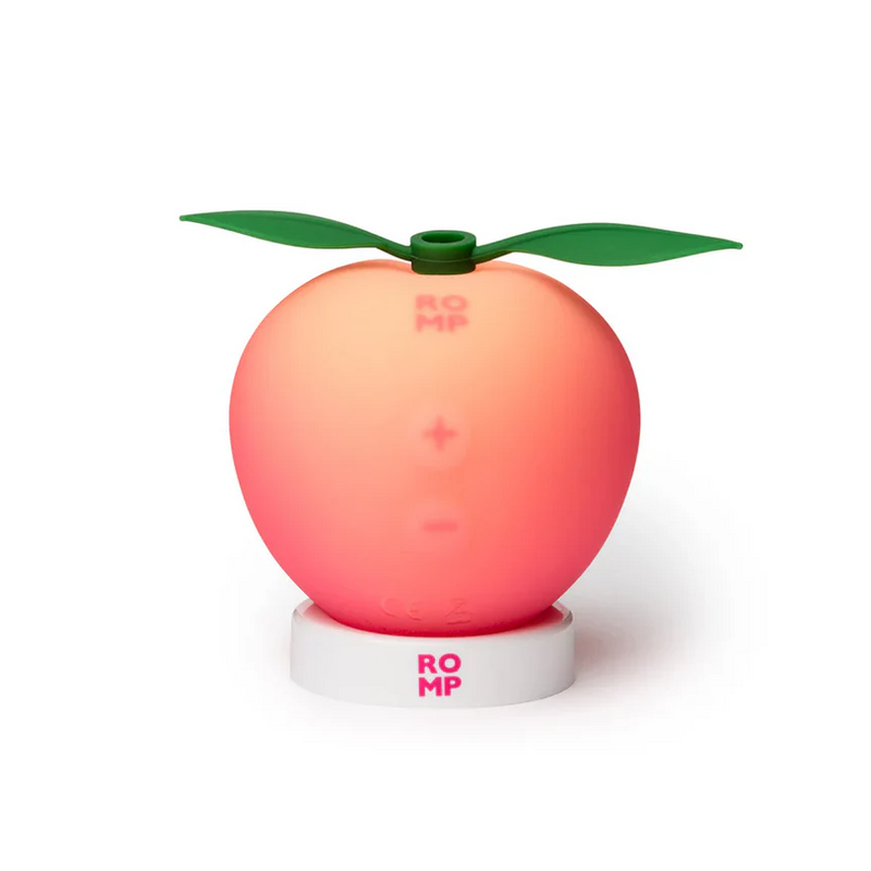 Romp Peach Pleasure Air Clitoris Stimulator: a compact, soft silicone peach-shaped toy with green leaves.