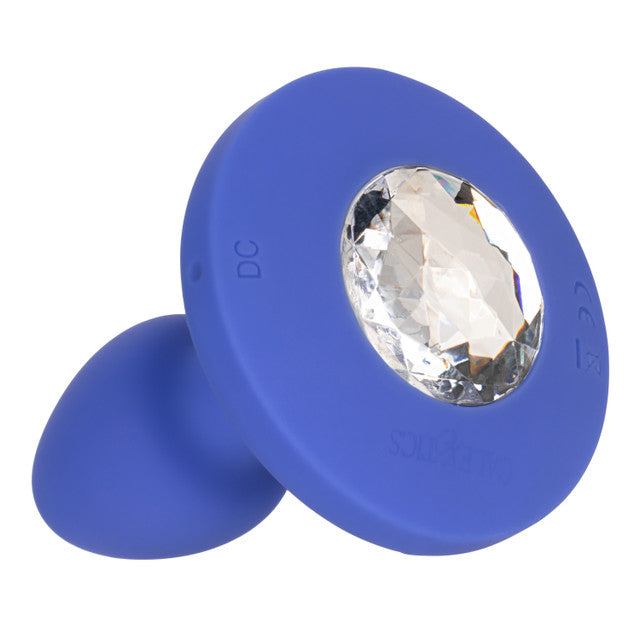 The Cheeky Gems Small Rechargeable Vibrating Butt Plug in blue, featuring a large clear faceted jewel at the base, adds sparkle and vibration to backdoor play—shown on a white background.