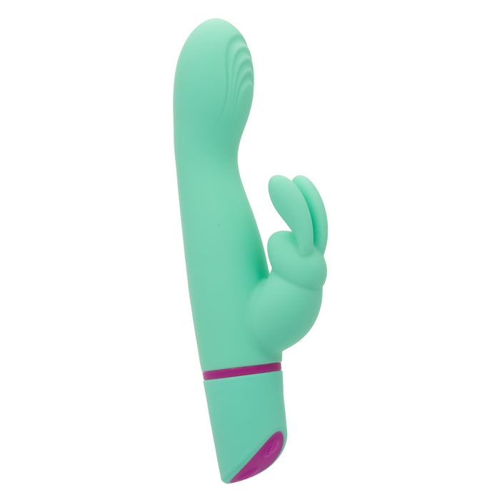 The Love Bunny Rockin’ G Triple Motor Rabbit Vibrator is a mint green silicone toy with a curved shaft, dual stimulating extensions, a purple accent at the base, and powerful triple motors for intensified G-spot pleasure.
