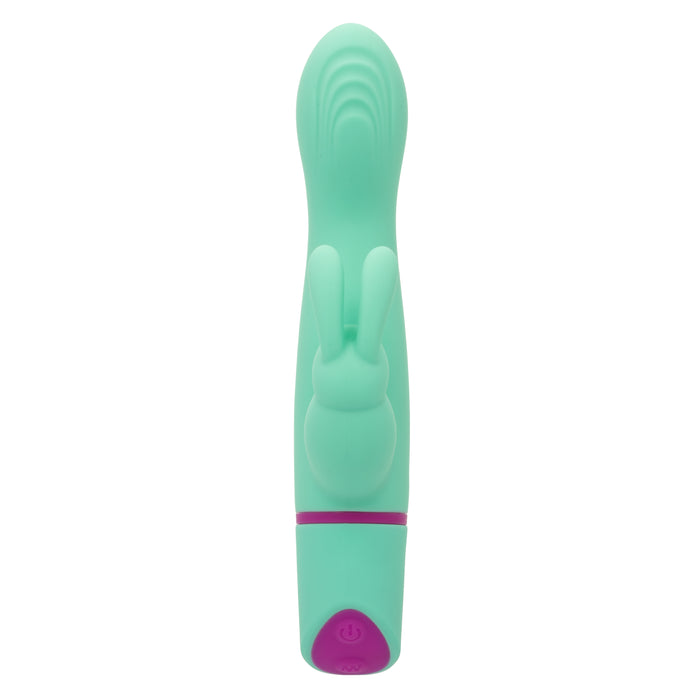 The Love Bunny Rockin’ G Triple Motor Rabbit Vibrator is a turquoise silicone toy with a bunny-shaped clitoral stimulator, triple motors, and purple controls at the base, shown upright on a white background.