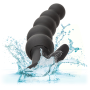 Black silicone Boundless Vibrating X5 Beaded Curved Anal Plug with water splashing around it.