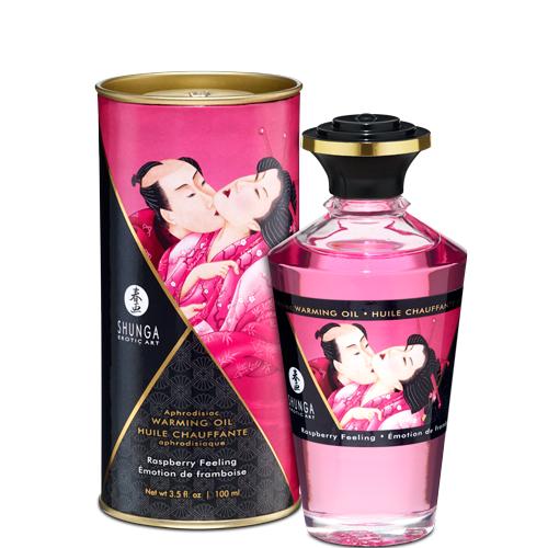 A bottle of Aphrodisiac Cherry Warming Oil for Erogenous Zones 100 ml sits beside its cylindrical packaging, both adorned with art of an embracing couple in traditional Japanese attire. This warming oil is safe for use with sex toys and enhances pleasure.