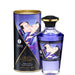 A bottle of Aphrodisiac Cherry Warming Oil for Erogenous Zones 100 ml sits before its cylindrical packaging, both featuring romantic Japanese art in purple and gold and labeled "Exotic Fruits.