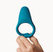 A hand holds up the Dame Hug Adjustable Vibrating Cock Ring for Couples, featuring a blue silicone design with a wider, flat top, against a plain white background.