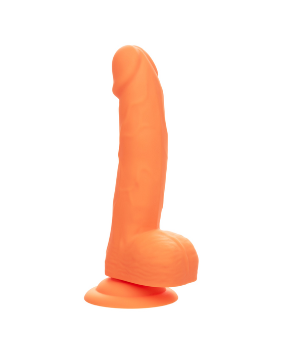 A CalExotics Silicone Stud 8 Inch Suction Cup Dildo - Orange with a realistic design and neon-hued delight, featuring a flared base for stability. The dildo is upright and slightly curved, showcasing detailed textures and veins for an authentic look. Its powerful suction cup base ensures hands-free fun.