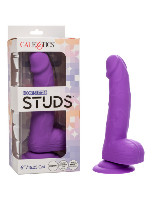 A packaged and unpackaged neon-hued purple Silicone Stud 8 Inch Suction Cup Dildo from CalExotics. The toy measures 8 inches (20.32 cm) and is designed to resemble a phallus with a suction cup base. The packaging features a geometric design and includes brand and product information.
