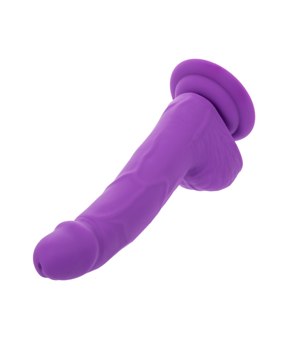 A neon-hued delight, the Silicone Stud 8 Inch Suction Cup Dildo - Purple by CalExotics sports a realistic design with veins and a defined head. Featuring a strong suction cup base, it can be attached to flat surfaces for hands-free pleasure.