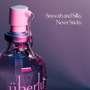 A 50 ml UberLube Premium Silicone Lubricant bottle with a pump dispenser sits against a purple background. Text reads: "Smooth and Silky. Never Sticky. Long lasting lube for an anti-chafe experience.