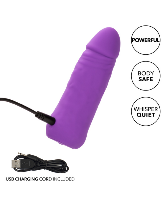 A purple, phallic-shaped vibrator with a USB charging cord connected to it is made from premium silicone. Three labels next to the Vibrating Stud Mini Cock Shaped Bullet Vibrator - Purple by CalExotics indicate it has "Powerful Speeds of Vibration," is "Body Safe," and "Whisper Quiet." A USB charging cord is shown in the bottom left corner of the image.