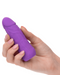 A hand with neatly manicured nails holds a CalExotics Vibrating Stud Mini Cock Shaped Bullet Vibrator - Purple crafted from premium silicone. The toy features realistic details, such as a contoured head and textured surface, and offers powerful speeds of vibration. It is shown against a plain white background.