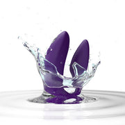 The We-Vibe Sync 2 Wearable Couples Vibrator in purple, remote and app controlled, splashes into clear water with droplets rising against a white background.