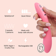 A hand holds the Ily Flexible Warming G-Spot Vibrator, featuring splashproof design, a quiet motor, 3 speeds/7 patterns, body-safe silicone, vegan/cruelty-free materials, USB rechargeability, and illustrated icons.