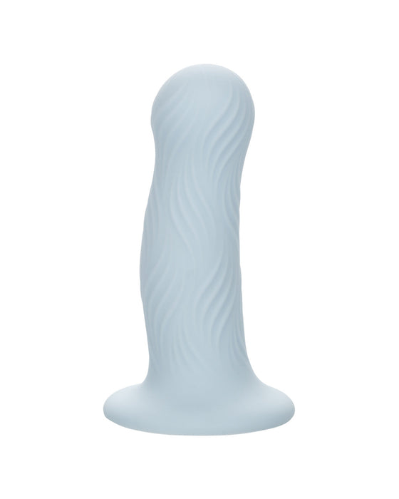 A pale blue, wavy-textured CalExotics Wave Rider Foam Short, Girthy 4.75 Inch Liquid Silicone Dildo with a curved and tapered shape, set on a sturdy base with a powerful suction cup, isolated on a white background.