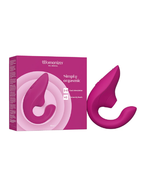 A pink, curved, dual stimulation personal massager is shown with its box. The box is also pink with white text that reads "Womanizer Blend Pleasure Air Clitoral & G-Spot Rabbit - Pink," highlighting 10 intensity levels. The product image on the box matches the actual G-spot vibrator device next to it.