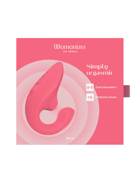 A pink box featuring the Womanizer Blend Pleasure Air Clitoral & G-Spot Rabbit - Rose. The packaging shows a pink, curved rabbit vibrator with dual stimulation and 8 intensity levels. The product name, "Womanizer Blend Pleasure Air Clitoral & G-Spot Rabbit - Rose," is prominently displayed.