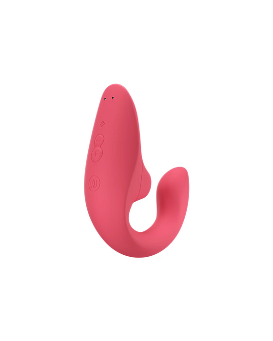 A Womanizer Womanizer Blend Pleasure Air Clitoral & G-Spot Rabbit - Rose, a red silicone rabbit vibrator with a curved design and a protruding tail-like end. It features control buttons, including a plus, minus, and power button, along with an LED indicator on its surface for dual stimulation.