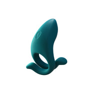 The Dame Hug Adjustable Vibrating Cock Ring for Couples, in teal silicone and shaped like a whale with two fin-like extensions, stands upright on a white background.