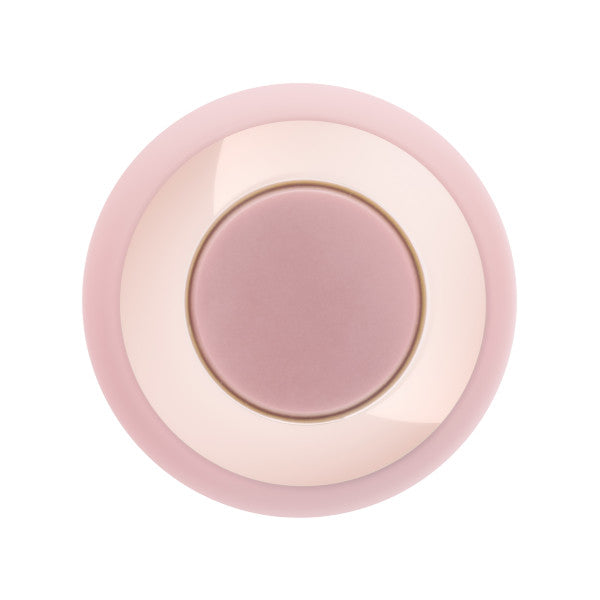 The Kissing Rose Vibrator with Tongue and Lips is a round, pink, body-safe silicone toy with a central button area and concentric circles in various pink shades, shown from above on a white background.