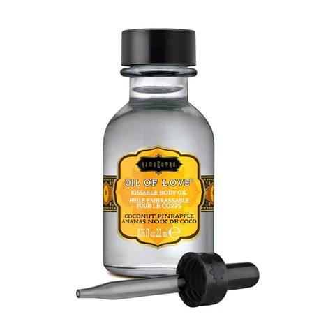 A small glass bottle of Kama Sutra Coconut Pineapple Kissable Foreplay Oil Of Love (.75 oz) with a black dropper cap, water-based for a tropical twist and perfect for kissable pleasures. Yellow and orange accents add to its exotic appeal.