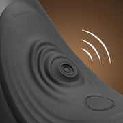Close-up of The Cowgirl Saddle Sex Machine with Vibration, Thrusting and Rocking in black, featuring ripple patterns, a round button, and "COWGIRL" engraving; white lines evoke hands-free pleasure and vibration on a brown background.