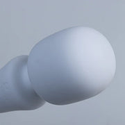 Close-up of the smooth, matte white silicone head of the Illumination Wand vibrator.