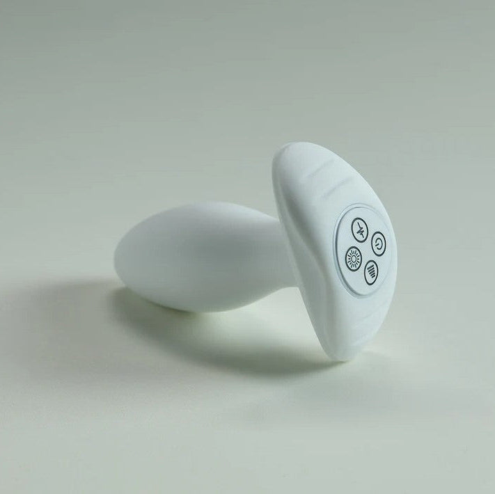 White silicone butt plug with a flared base featuring control buttons.