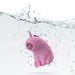 The Dreamy Licks – The Whimsical Unicorn Tongue Vibrator is a pink, cartoon-inspired unicorn made of body-safe silicone with a purple horn and closed eyes, pictured underwater with bubbles and splashes on a white background.
