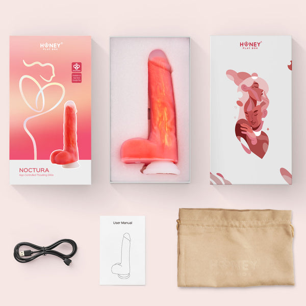 The Noctura Thrusting Silicone Dildo with App Control, in pink, is waterproof and features a suction base. It comes packaged with a USB charging cable, user manual, and beige storage pouch—all arranged on a light surface.