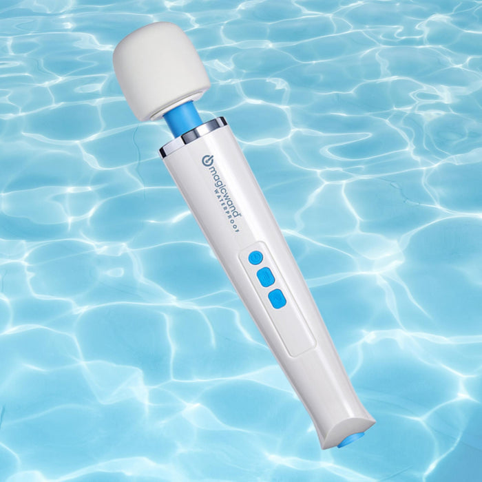 The Magic Wand Waterproof Rechargeable Cordless Vibrator, featuring blue buttons, floats over clear, rippling pool water.