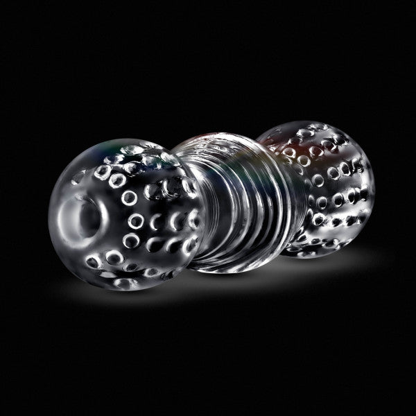 The Rize Feelz Clear Textured Stroker features a clear glass-look sleeve with rounded, bump-covered ends and a ridged center, reversible for enhanced sensation—all shown against a black background.