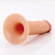 The Fantasy X-Tensions Elite Hollow 5 Inch Silicone Dildo & Strap-On Harness - Vanilla, featuring a dual-density design with a flared base and textured shaft, rests on a white surface.